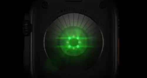 Back of Apple Watch Ultra 4, titanium case, black color, multiple round sensors with glowing green LED lights