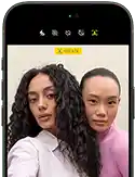 iPhone 18 Pro, black, front exterior, displaying two models posing for the camera, demonstrating the Center Stage front camera